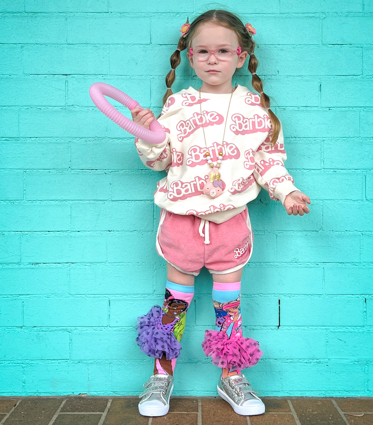 Colorful Barbie knee high socks with playful fashion-inspired graphics and tutu details.